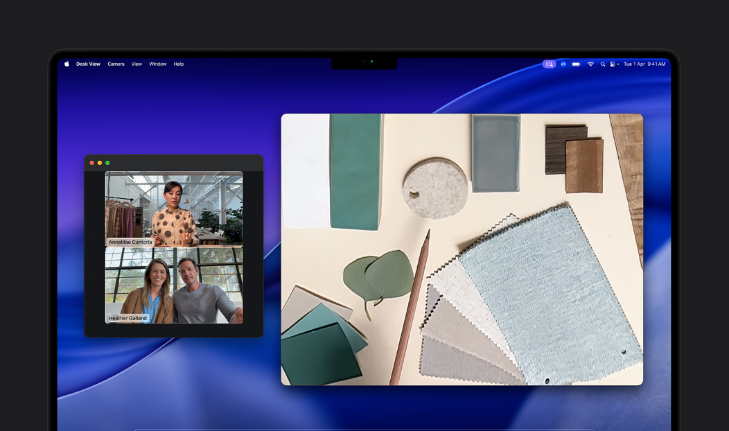 A video call on MacBook Pro of a woman using the Desk View feature to show her workspace filled with fabric squares to two people on the call, Desk View lets her show her workspace and her face simultaneously