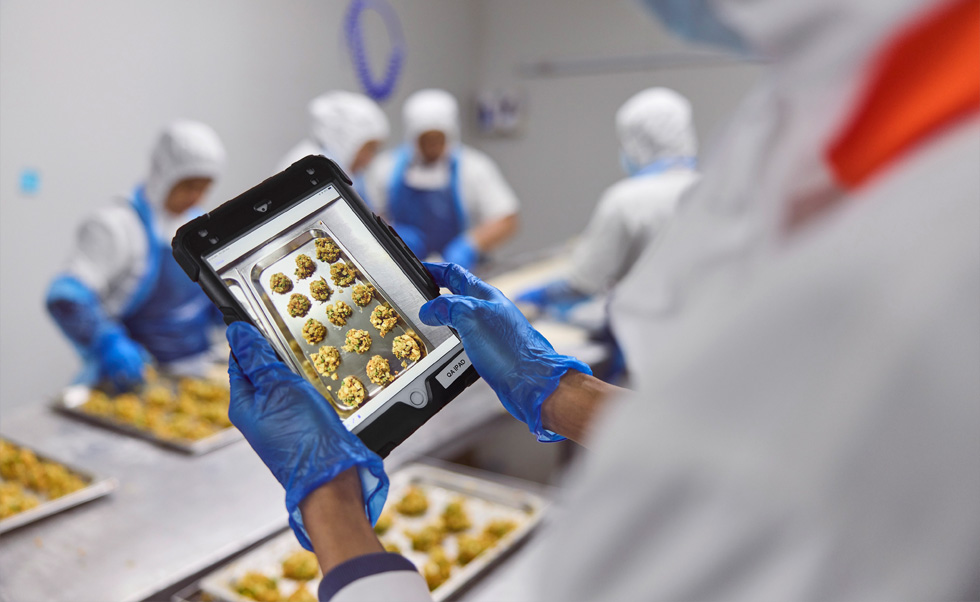 Một nhân viên đang thực hiện khâu kiểm soát chất lượng trên iPad.