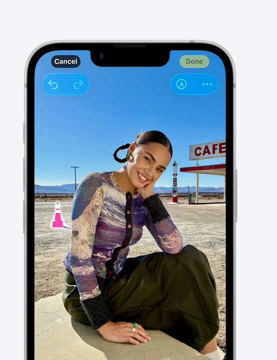 iPhone screen, photo of person smiling on beach, showing how to remove a cone in the background with the Clean Up tool