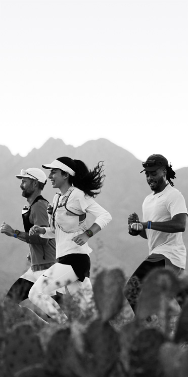Three people running on a desert trail track their workout on Apple Watch Ultra 3